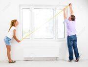 22096628-couple-is-measuring-their-new-empty-apartment-Stock-Photo